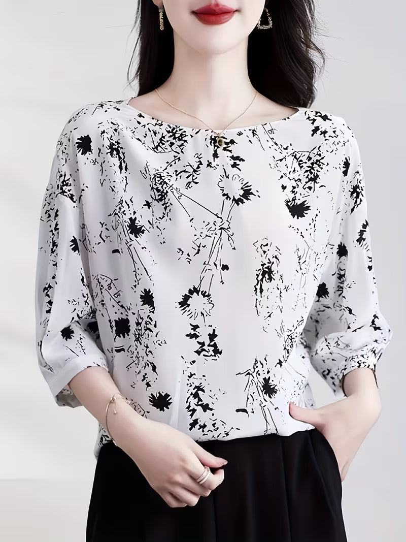 This modern Top features a refined black floral and abstract line print Top