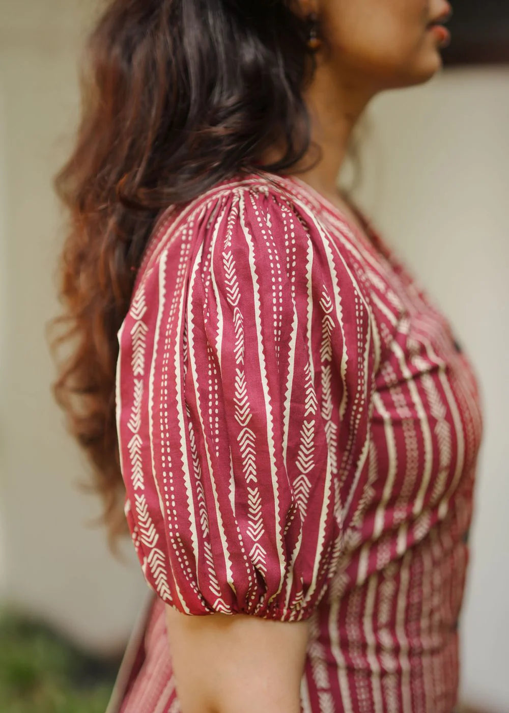 A classy cream &amp; multicolor striped dress featuring a V neck