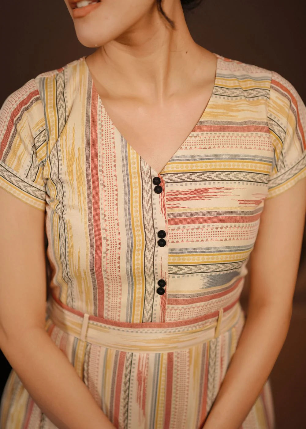 A classy cream &amp; multicolor striped dress featuring a V neck