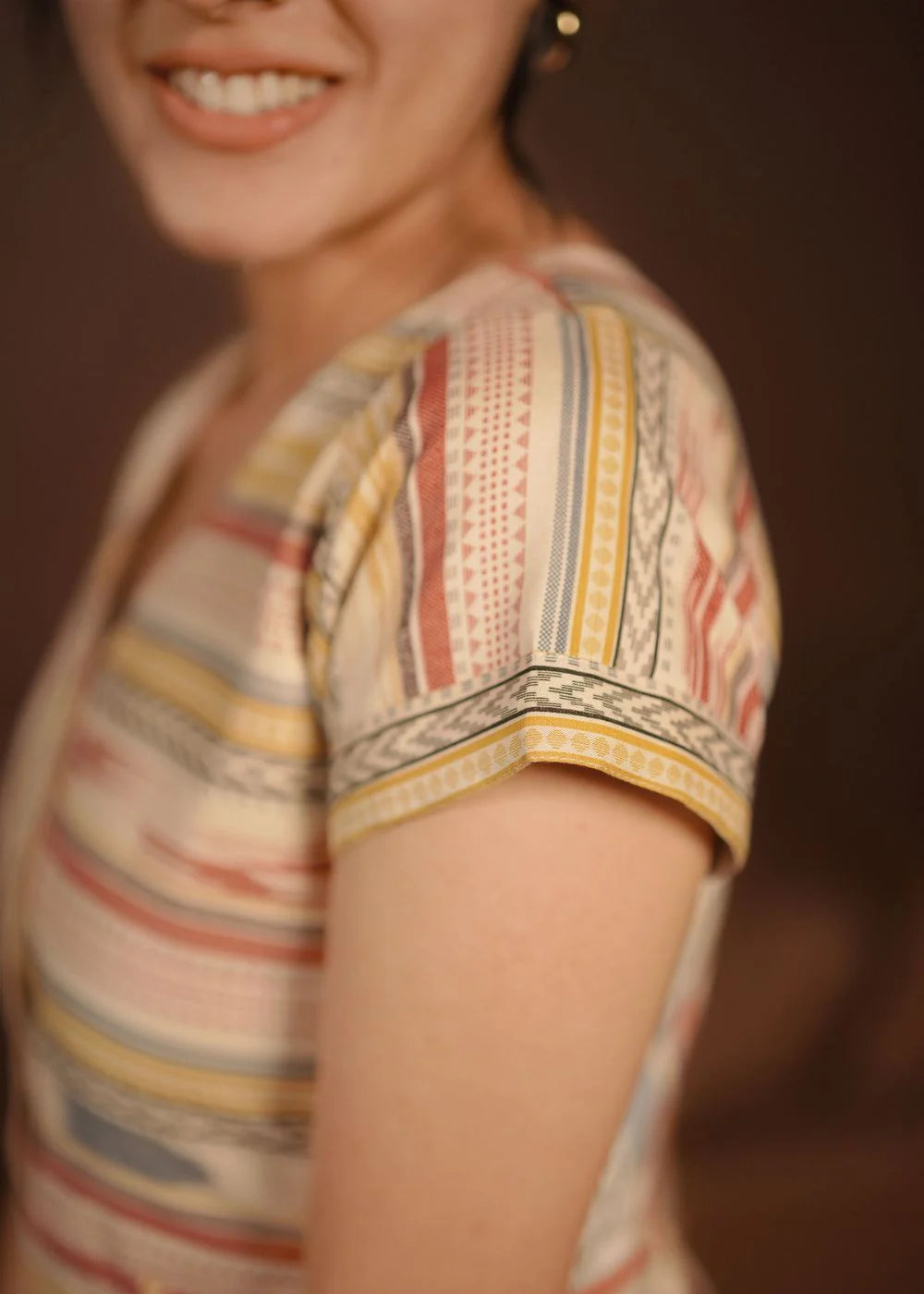 A classy cream &amp; multicolor striped dress featuring a V neck