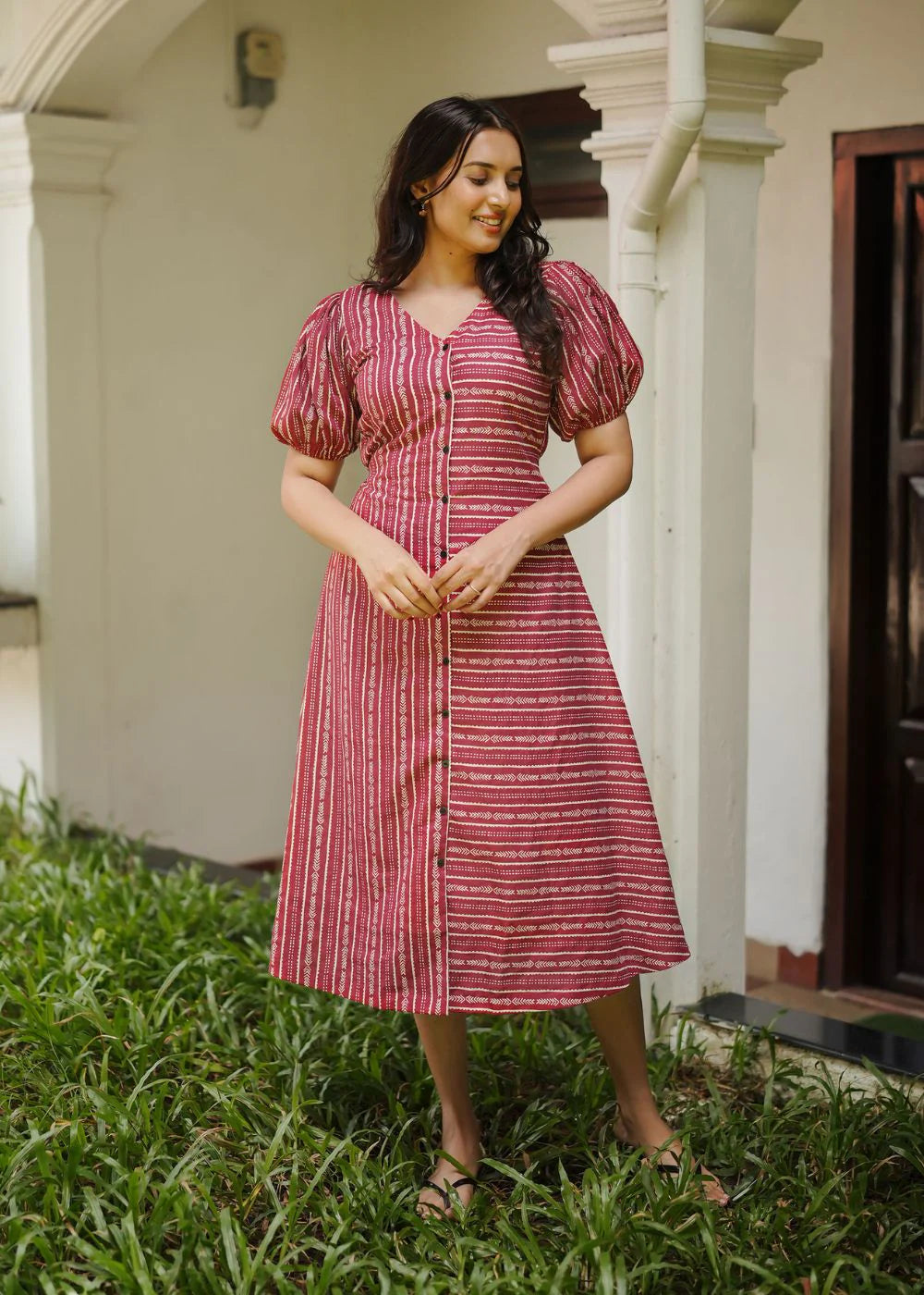 A classy cream &amp; multicolor striped dress featuring a V neck