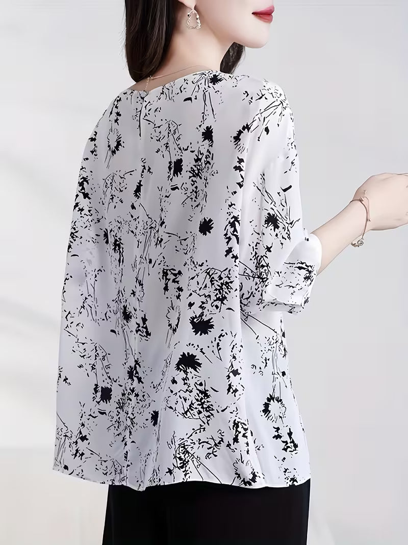 This modern Top features a refined black floral and abstract line print Top