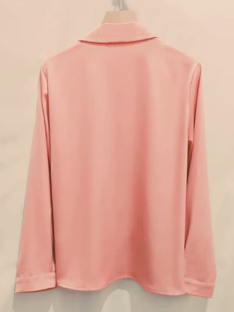 Elegant shirt is crafted from a lustrous silk satin