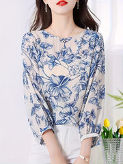 This graceful Top features a soothing palette of blue floral prints
